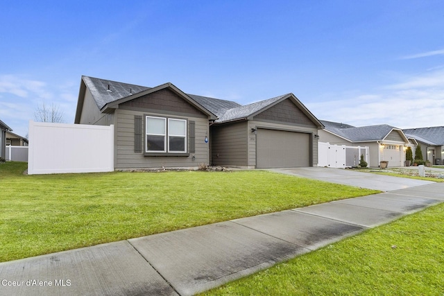 ranch-style house featuring a front lawn and a garage