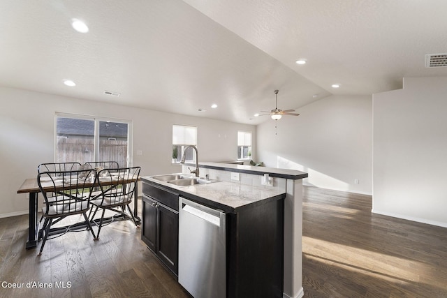 kitchen with lofted ceiling, a center island with sink, sink, stainless steel dishwasher, and dark hardwood / wood-style floors