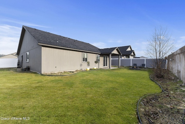 rear view of house with a yard