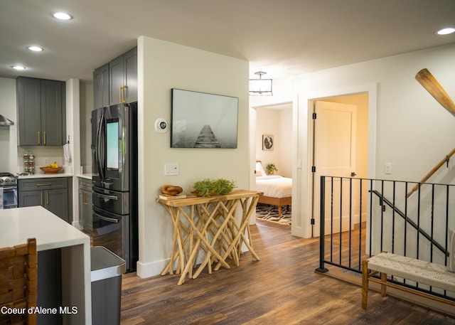 kitchen featuring gray cabinetry, stainless steel fridge, and dark hardwood / wood-style flooring