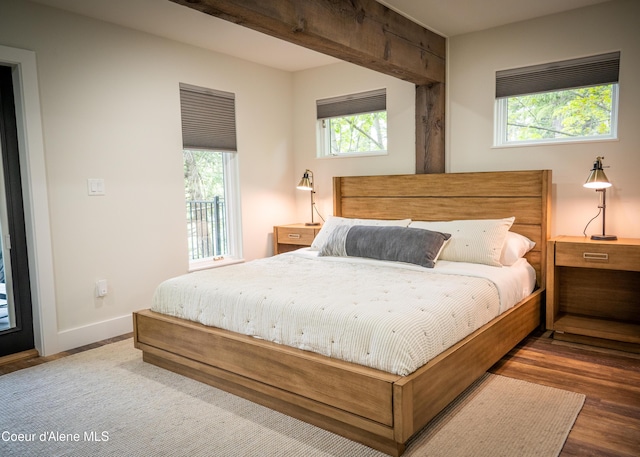 bedroom with multiple windows and hardwood / wood-style floors