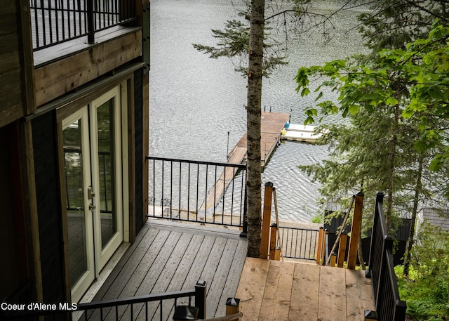 exterior space with french doors and a water view