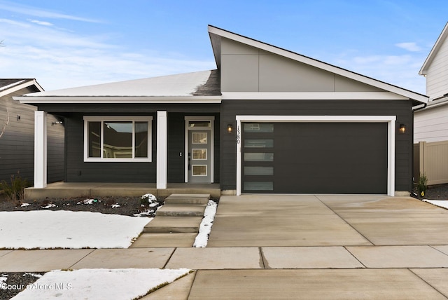 view of front of home featuring a porch and a garage