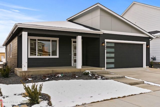 view of front of property with a garage and covered porch