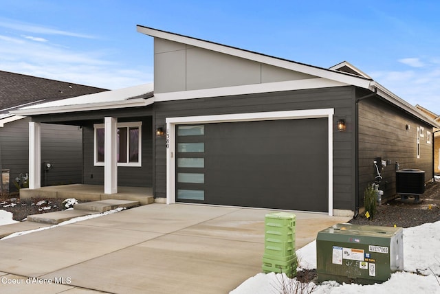 view of front of house with cooling unit and a garage