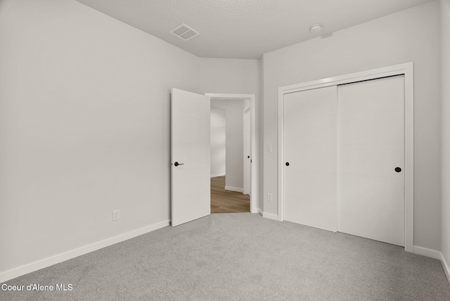 unfurnished bedroom featuring a closet and carpet