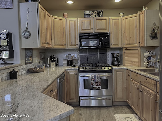 kitchen featuring tasteful backsplash, sink, decorative light fixtures, and stainless steel range with gas stovetop