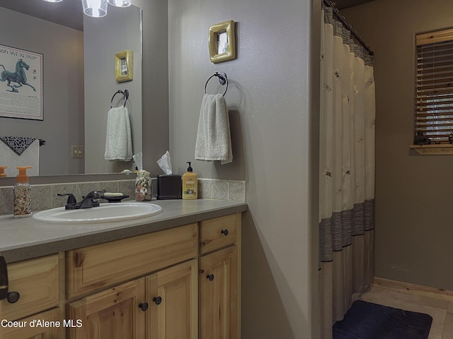 bathroom featuring tile patterned floors, a shower with curtain, and vanity