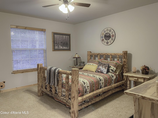 bedroom featuring light colored carpet and ceiling fan