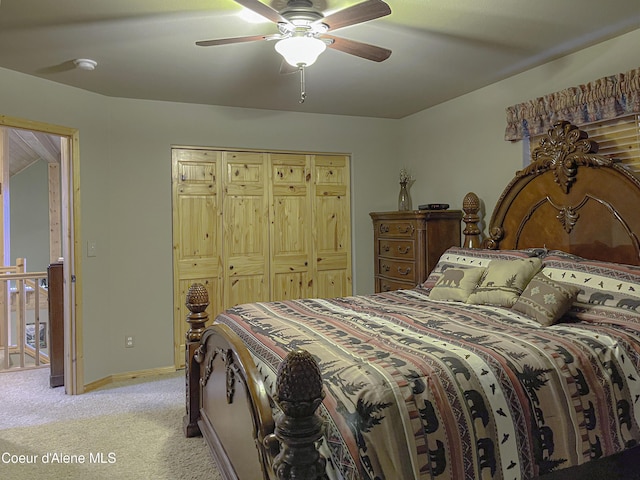 bedroom featuring ceiling fan, a closet, and light carpet