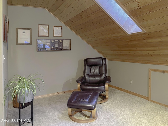 living area with vaulted ceiling with skylight, carpet, and wooden ceiling