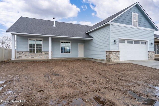 view of front of home with covered porch and a garage