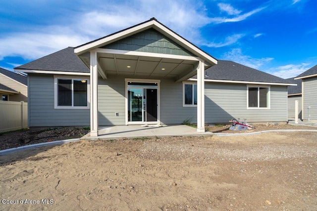 back of property with a patio