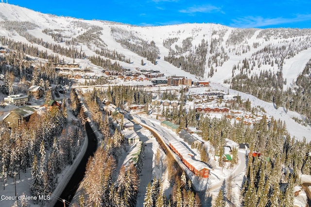 snowy aerial view featuring a mountain view