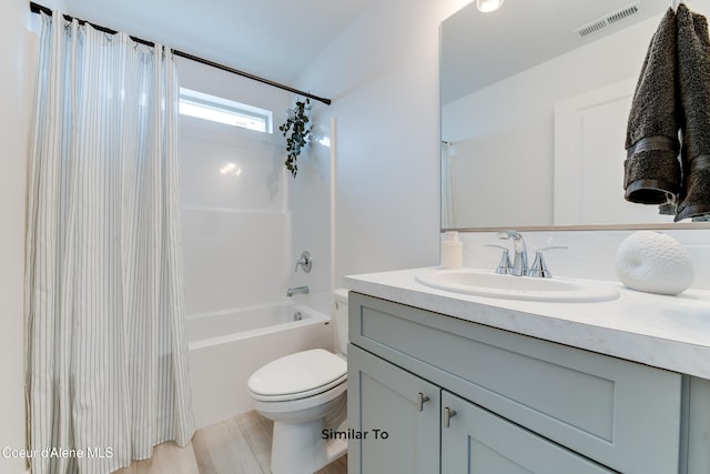 full bathroom featuring toilet, shower / tub combo with curtain, and vanity