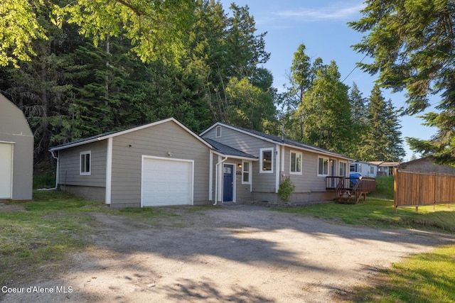 view of front of house with a garage and an outbuilding