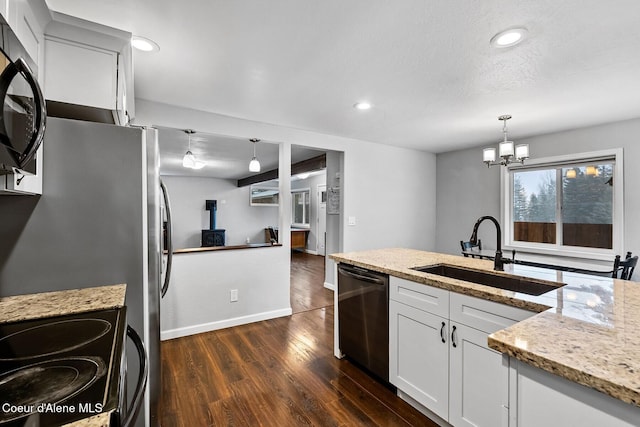 kitchen featuring light stone countertops, dishwasher, decorative light fixtures, white cabinetry, and sink