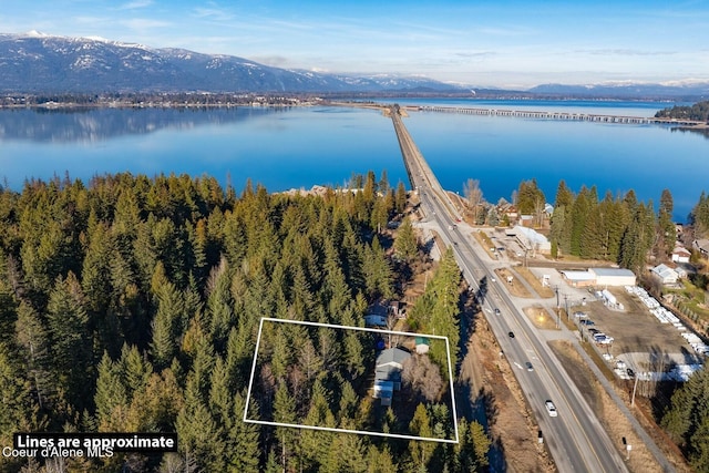 bird's eye view with a water and mountain view