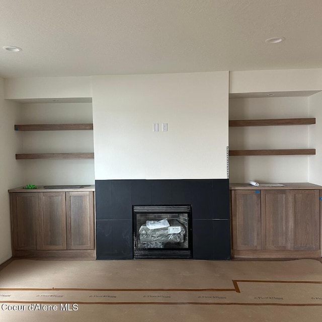 room details featuring a tiled fireplace