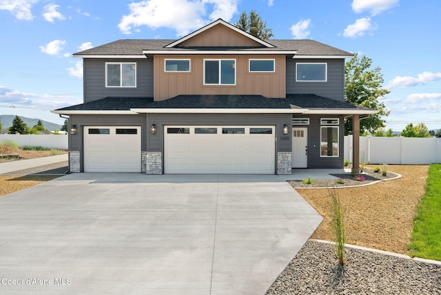 1605 N Garvin Ct, Spokane Valley, WA 99016 - view of front facade with a garage, driveway, and stone siding