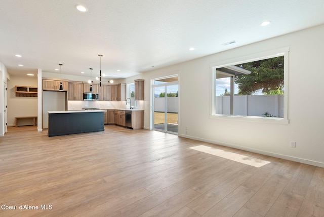1605 N Garvin Ct, Spokane Valley, WA 99016 - kitchen with stainless steel appliances, light countertops, recessed lighting, open floor plan, and baseboards