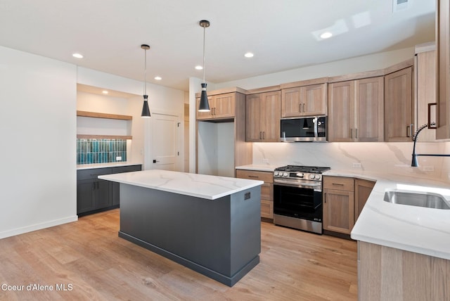 1605 N Garvin Ct, Spokane Valley, WA 99016 - kitchen with stainless steel appliances, open shelves, light stone countertops, light wood-style floors, and a sink