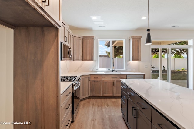 1605 N Garvin Ct, Spokane Valley, WA 99016 - kitchen with stainless steel appliances, a sink, light wood-style floors, light stone countertops, and recessed lighting