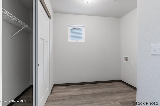 laundry room with hardwood / wood-style floors and hookup for a washing machine