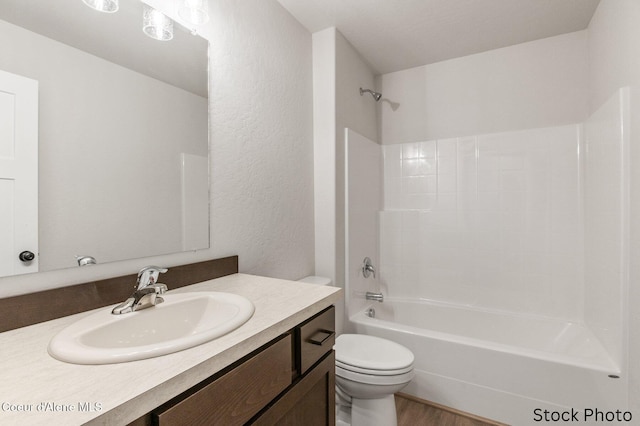 full bathroom with vanity, wood-type flooring, bathtub / shower combination, and toilet