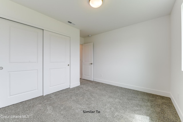 unfurnished bedroom with a closet and carpet