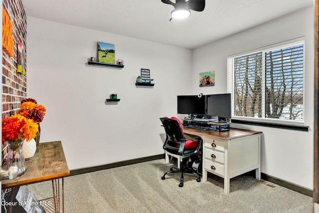 office space featuring carpet flooring, a ceiling fan, and baseboards