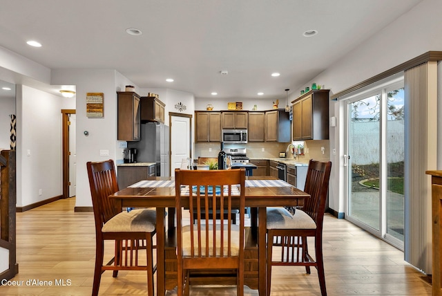 dining area with recessed lighting, baseboards, and light wood-style floors