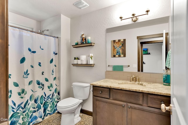 bathroom with vanity, baseboards, visible vents, curtained shower, and toilet