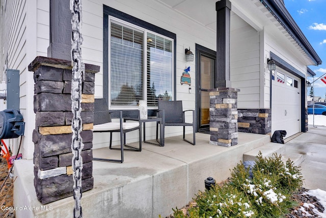 view of patio / terrace with covered porch and a garage