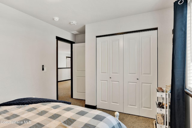 bedroom featuring carpet and a closet