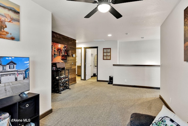 living area featuring recessed lighting, baseboards, and carpet