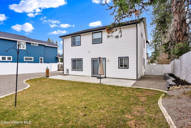 back of house with a fenced backyard, a yard, and a patio