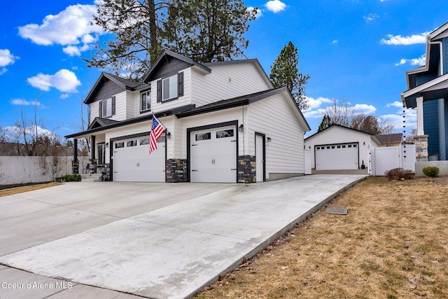 view of side of home featuring fence and stone siding