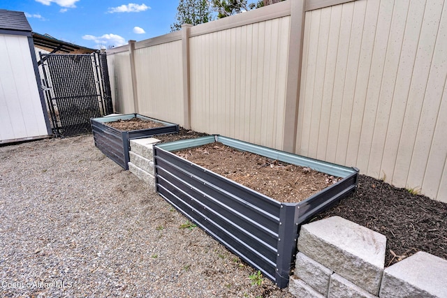 exterior details with a vegetable garden and fence