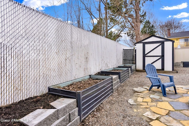 exterior space with a garden, a storage unit, an outbuilding, and fence