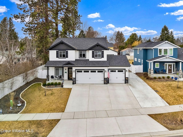 traditional-style home with fence, covered porch, a shingled roof, a front lawn, and concrete driveway