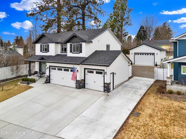 traditional-style home with a shingled roof and fence