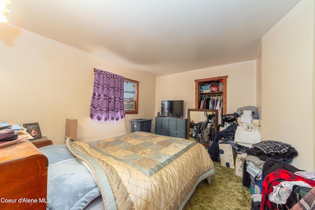 bedroom featuring carpet flooring and cooling unit