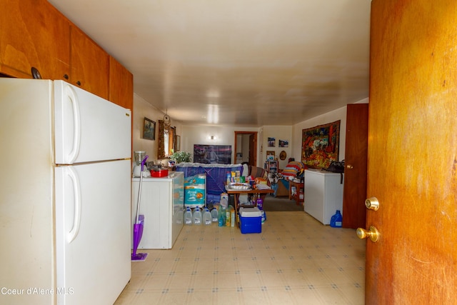 kitchen with washer / dryer and white fridge