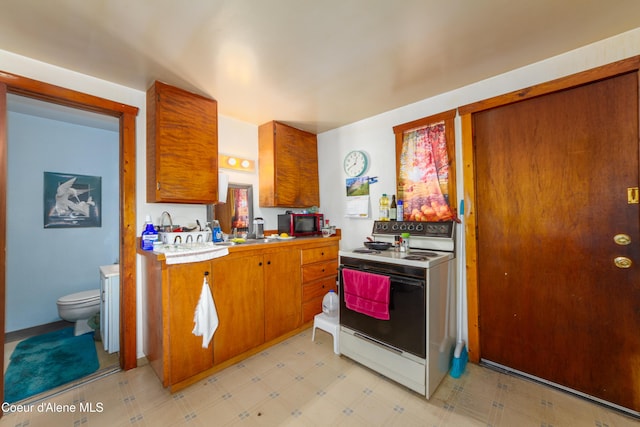 kitchen with white electric range oven and sink