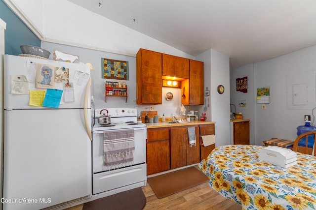 kitchen featuring light hardwood / wood-style floors, white appliances, sink, and vaulted ceiling