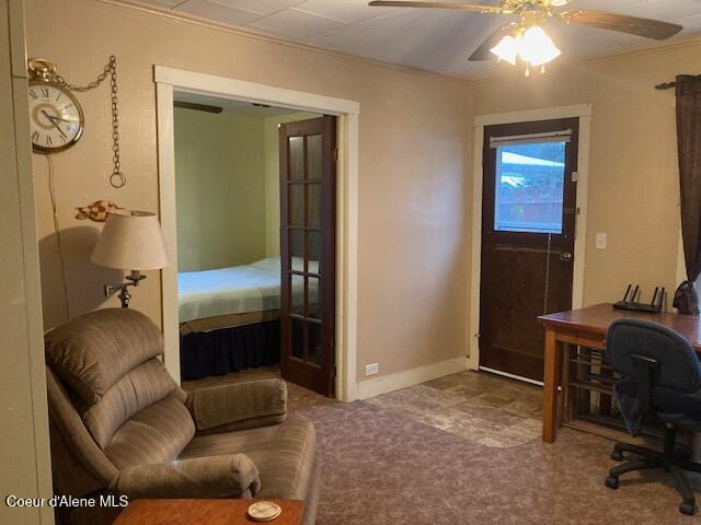 carpeted home office featuring ceiling fan