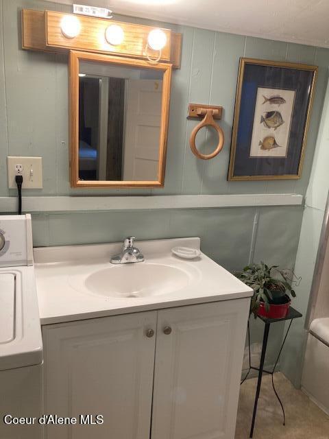 bathroom with vanity and washer / clothes dryer