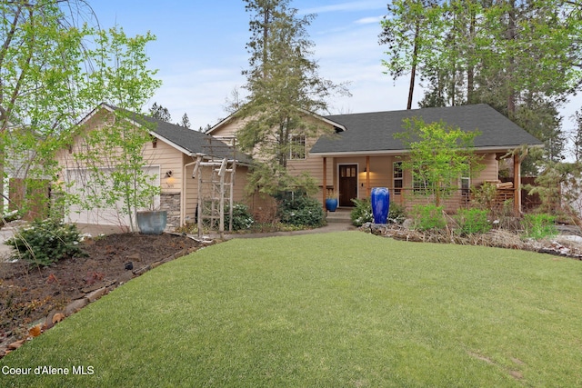 view of front of property with a front yard, a garage, and covered porch