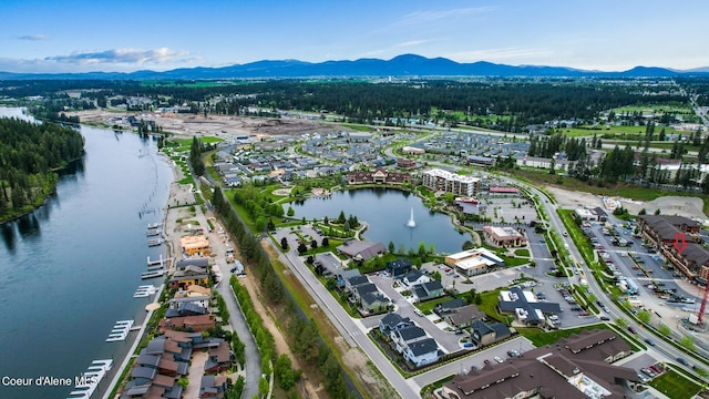 drone / aerial view with a water and mountain view